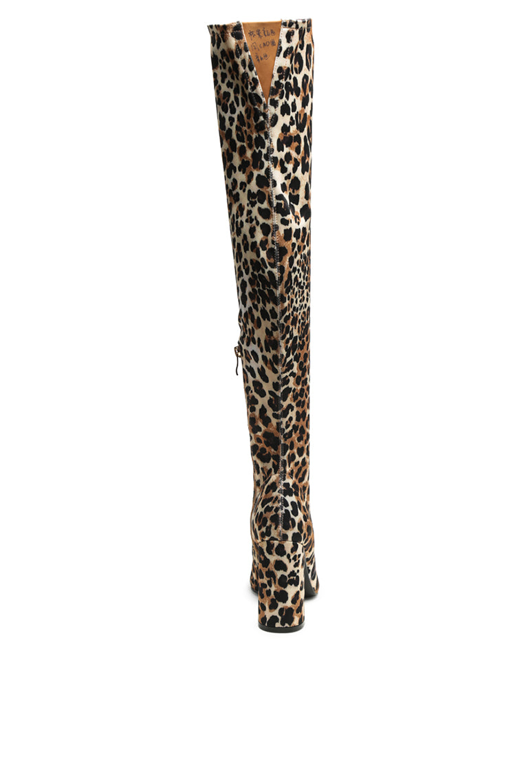 Flittle Over-The-Knee Boots featuring a stylish design with a block heel and pointed toe, made from faux leather.