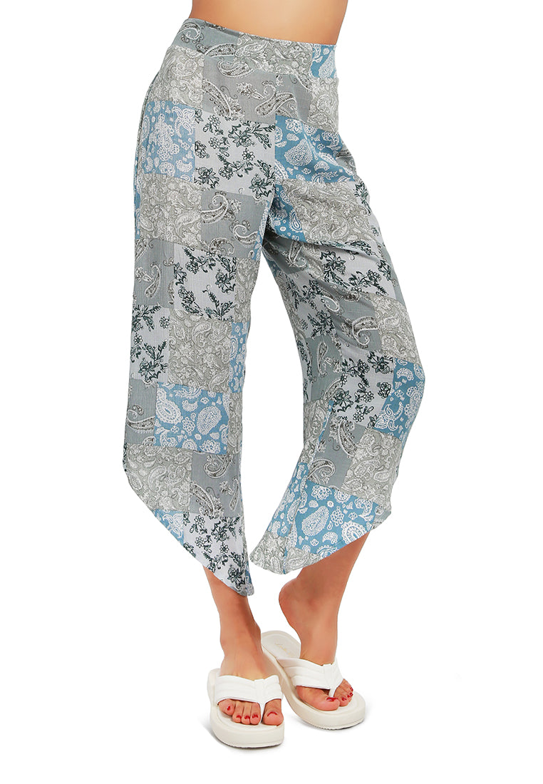 Floral Patchwork Print Pants featuring an asymmetrical hemline and vibrant floral designs, made from lightweight rayon fabric.