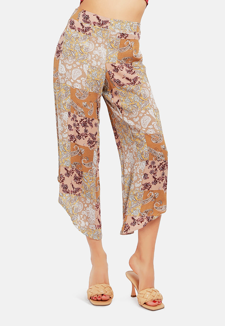 Floral Patchwork Print Pants featuring an asymmetrical hemline and vibrant floral designs, made from lightweight rayon fabric.