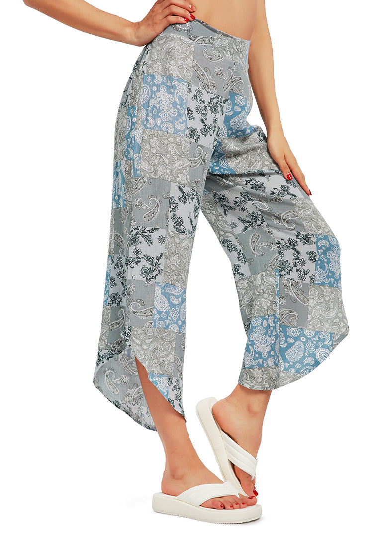 Floral Patchwork Print Pants featuring an asymmetrical hemline and vibrant floral designs, made from lightweight rayon fabric.