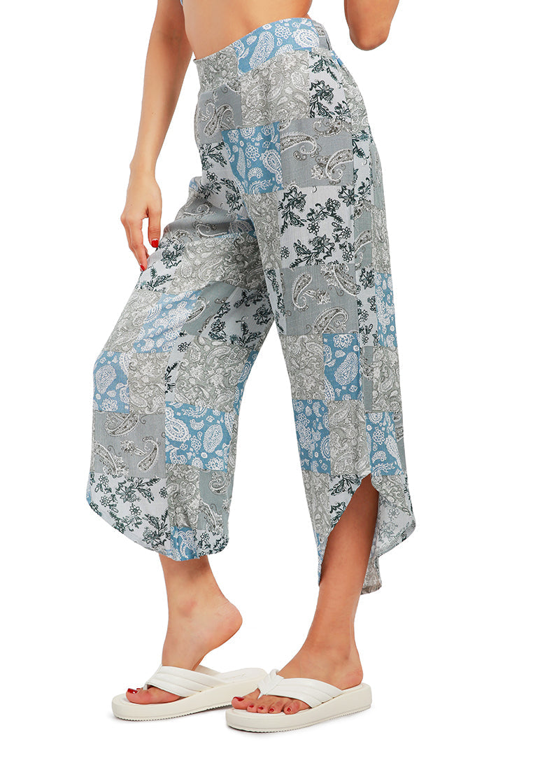 Floral Patchwork Print Pants featuring an asymmetrical hemline and vibrant floral designs, made from lightweight rayon fabric.