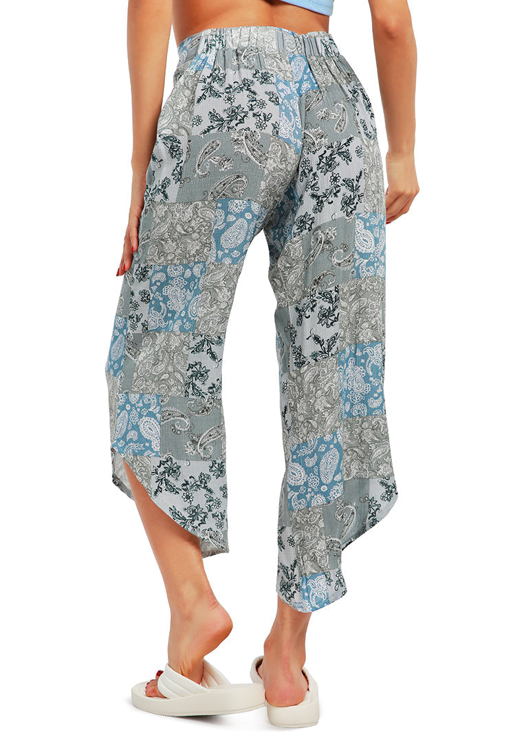 Floral Patchwork Print Pants featuring an asymmetrical hemline and vibrant floral designs, made from lightweight rayon fabric.