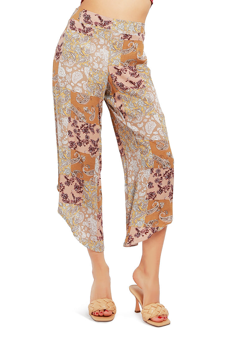 Floral Patchwork Print Pants featuring an asymmetrical hemline and vibrant floral designs, made from lightweight rayon fabric.