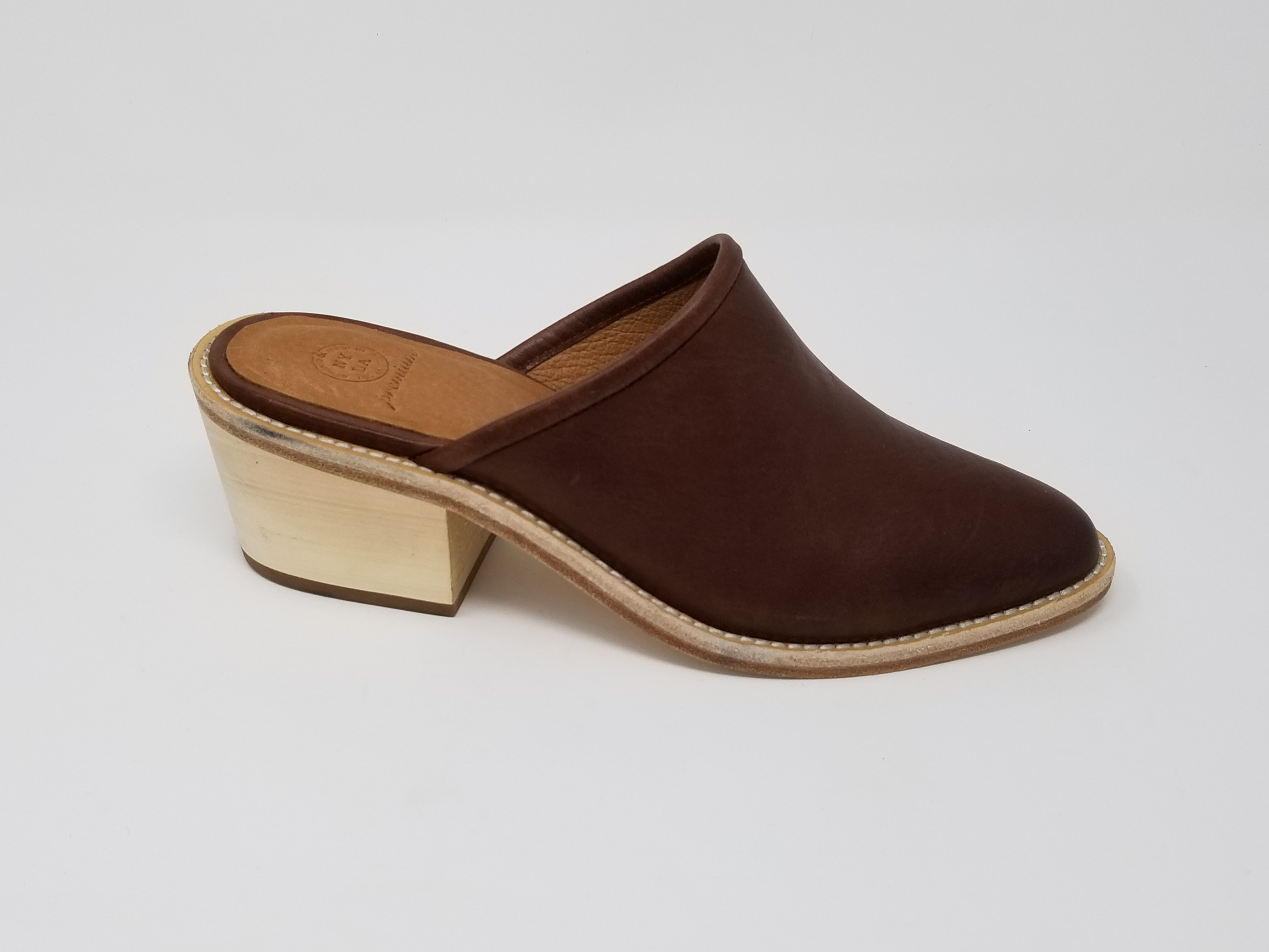 A pair of elegant Foxhill shoes featuring a full leather upper, memory foam insole, and stylish wood heel, perfect for any occasion.