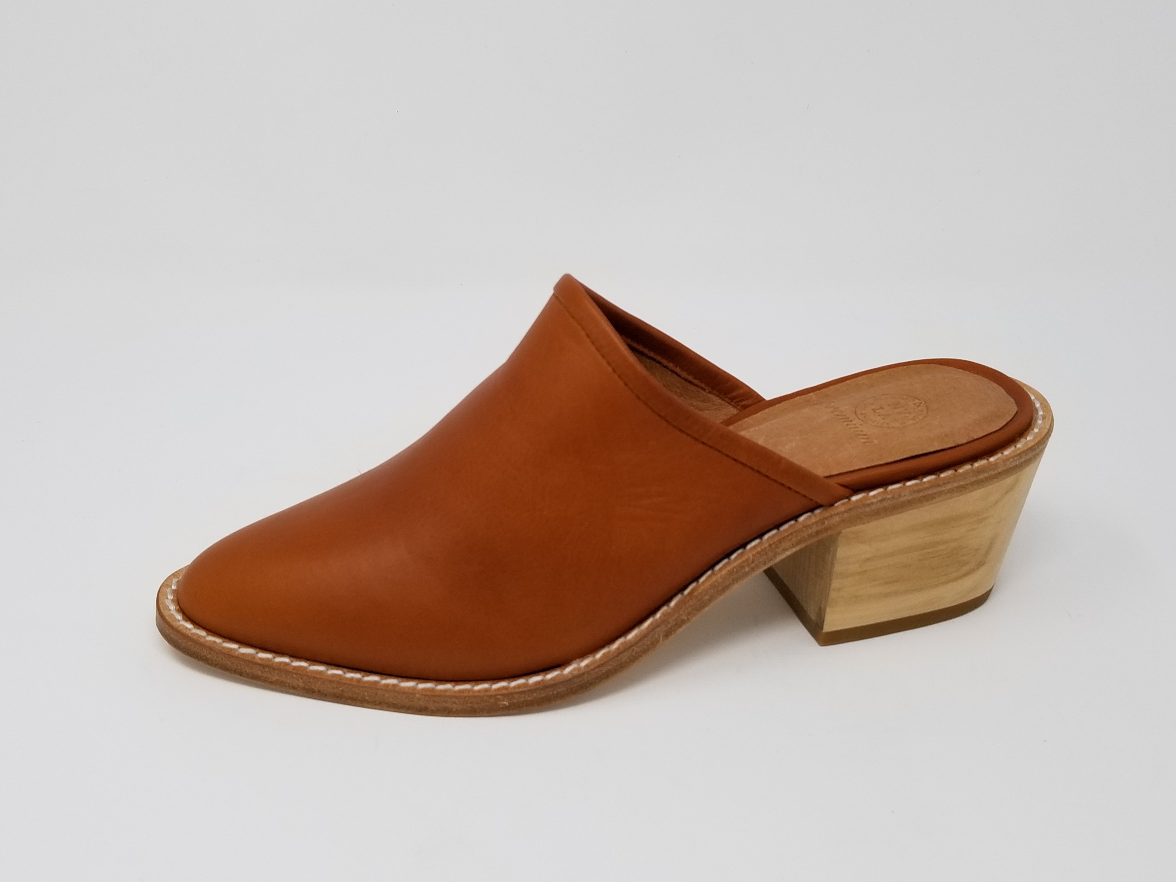 A pair of elegant Foxhill shoes featuring a full leather upper, memory foam insole, and stylish wood heel, perfect for any occasion.