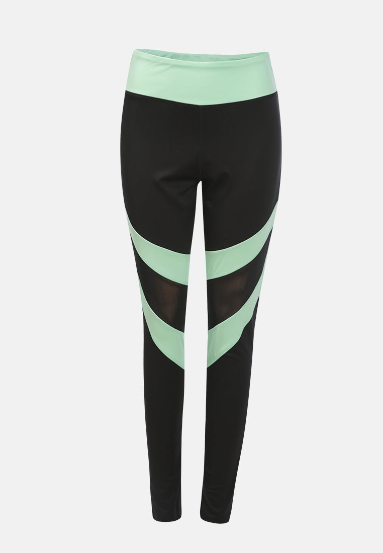 Geometric Paneled Mesh Yoga Leggings in black with white side seams, showcasing a high-rise fit and broad elastic waistband.