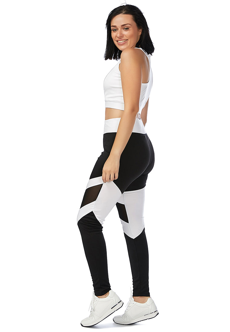 Geometric Paneled Mesh Yoga Leggings in black with white side seams, showcasing a high-rise fit and broad elastic waistband.