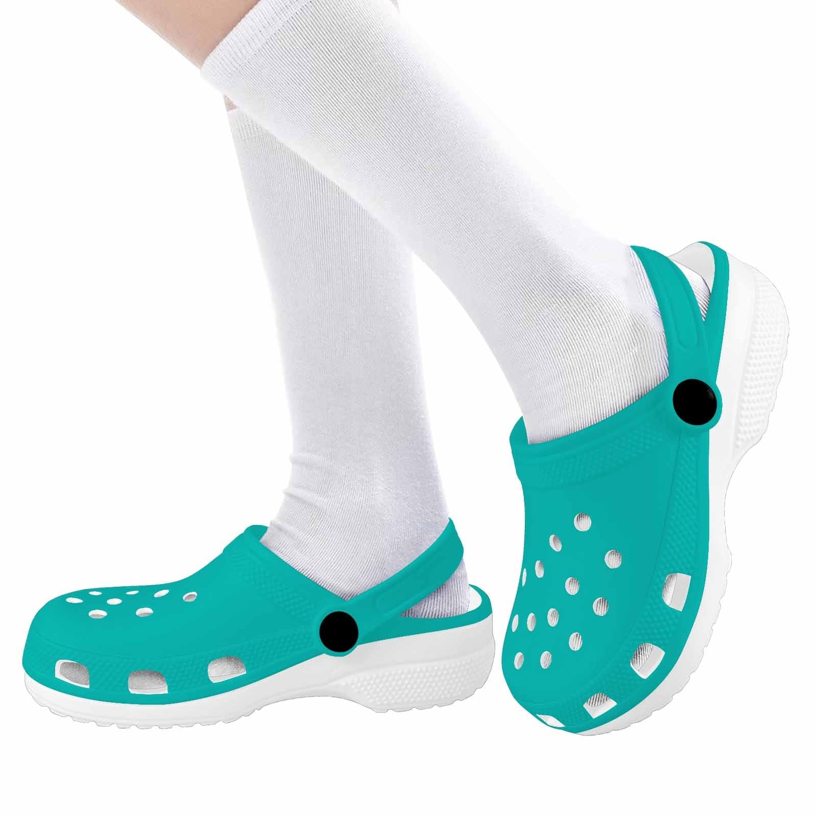 A pair of stylish green blue clogs designed for youth, featuring a slip-on design and cushioned sole for comfort.