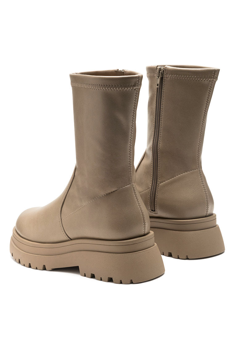 Stylish taupe high ankle boots with side zipper and lug sole design, perfect for various occasions.