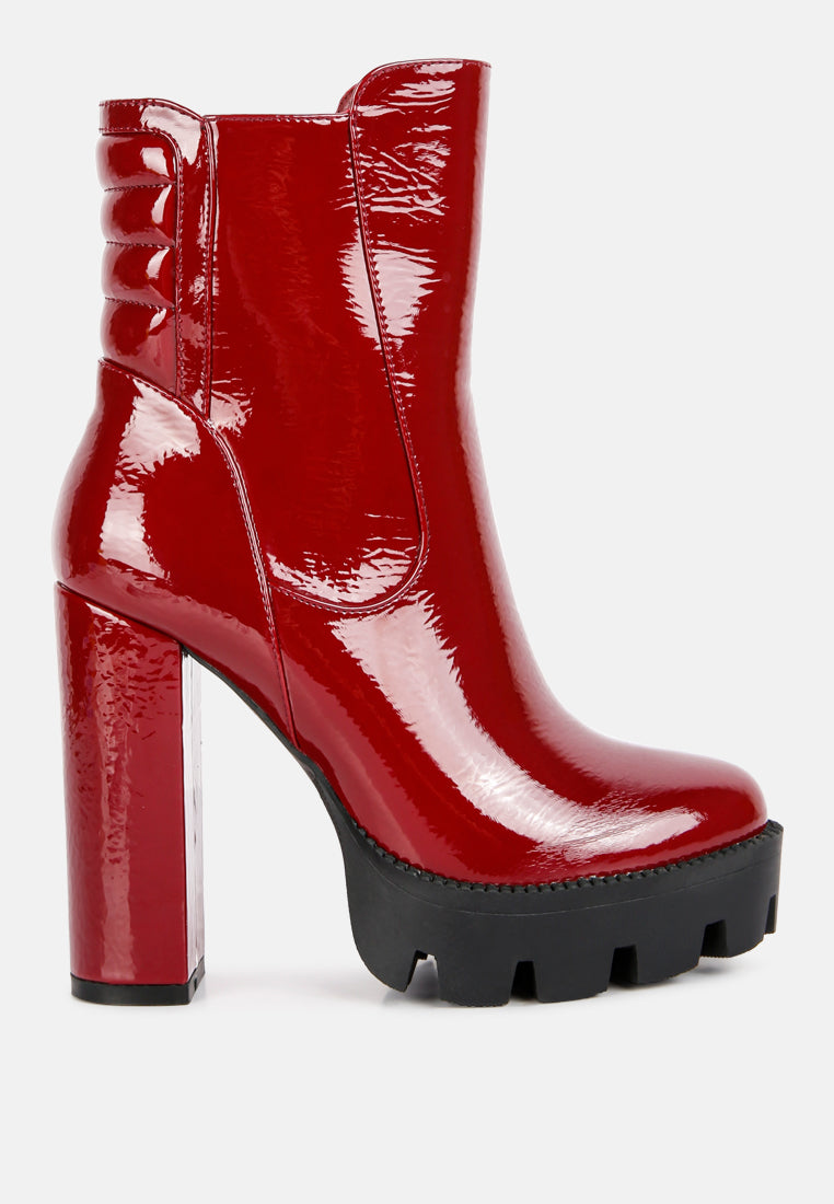 High Key Collared High Heel Ankle Boot featuring a shiny patent faux leather exterior, quilted collar, and edgy lug sole.