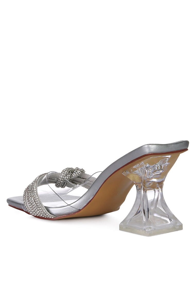 Hiorda Rhinestone Knotted Spool Heel Sandals featuring clear faux leather, rhinestone embellishments, and a stylish spool heel.