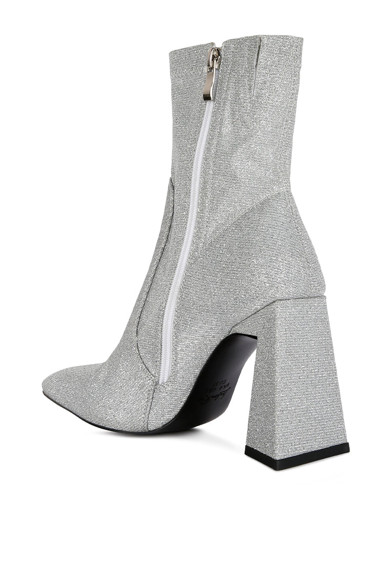 Hustlers Shimmer Block Heeled Ankle Boots featuring a shiny textile, block heels, and a side zipper for easy wear.