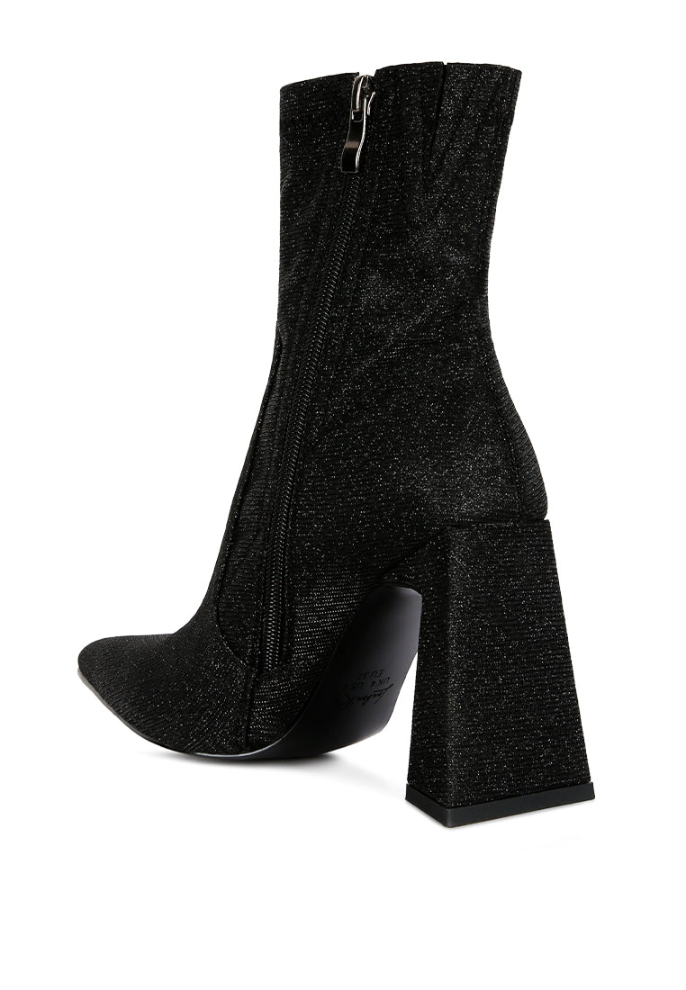 Hustlers Shimmer Block Heeled Ankle Boots featuring a shiny textile, block heels, and a side zipper for easy wear.