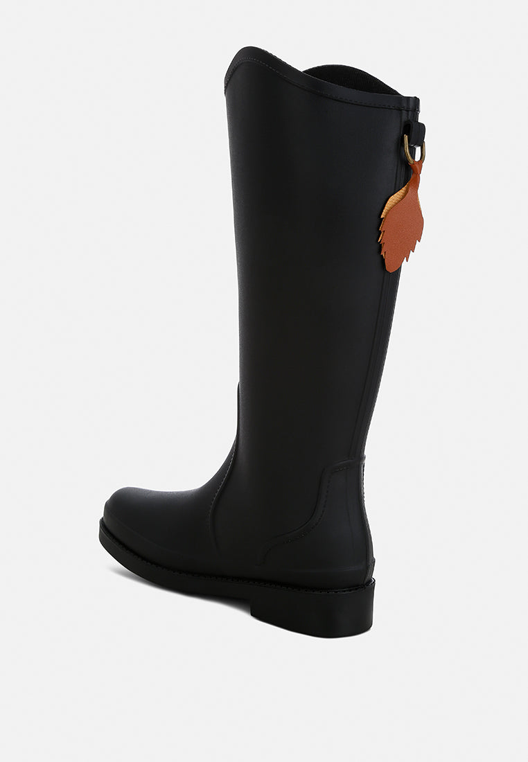 Indiana Charm Detail Calf Boots featuring a unique charm design, zipper closure, and a stylish synthetic upper material.