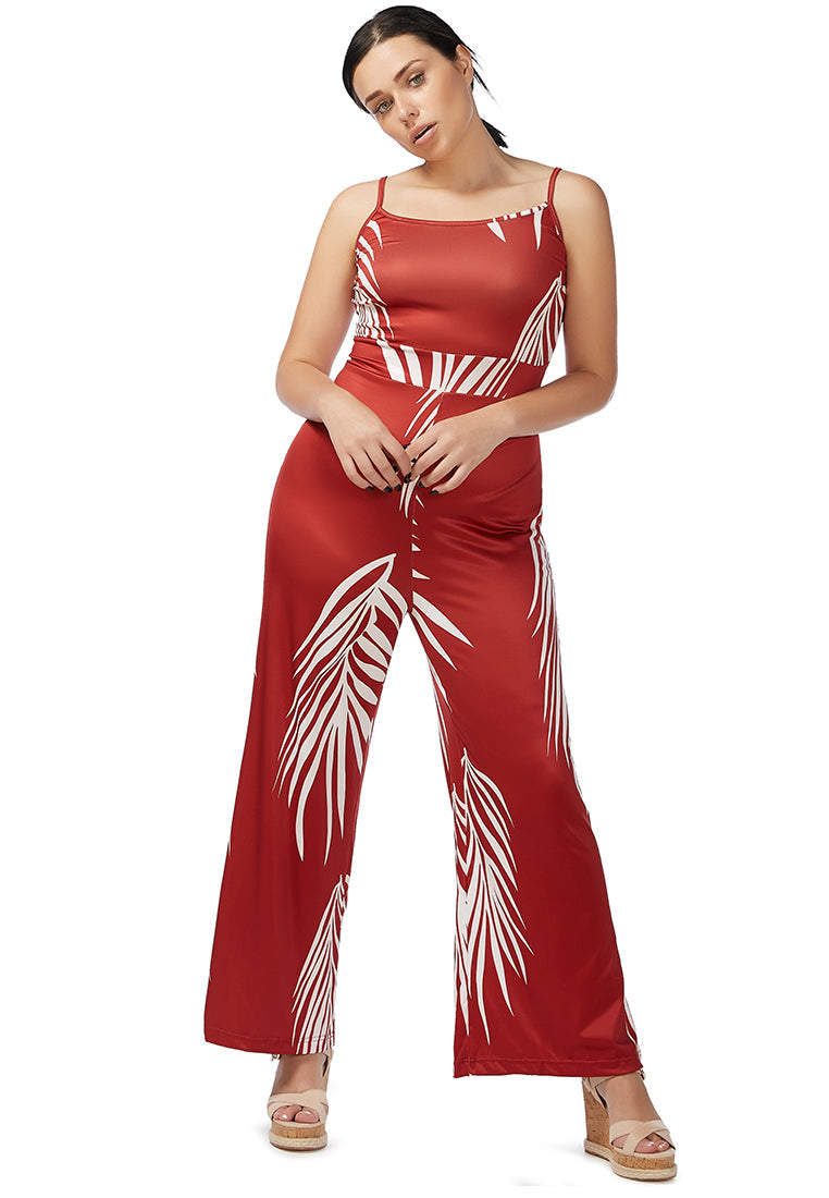 A stylish spaghetti strap jumpsuit featuring a white palm leaves print, perfect for beach outings and summer events.