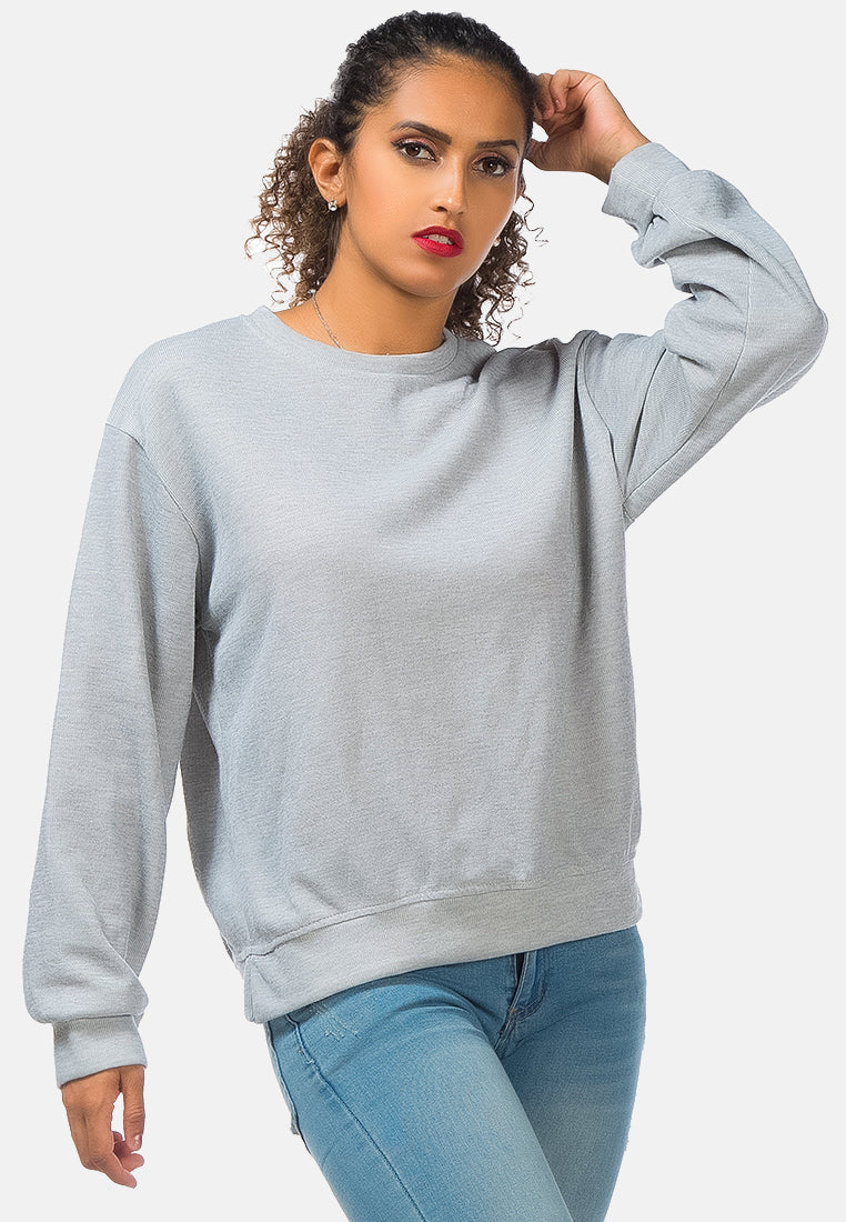 A cozy knitted long sleeve pullover sweatshirt with a crew neckline, ribbed hem, and side slits, made from soft cotton fabric.