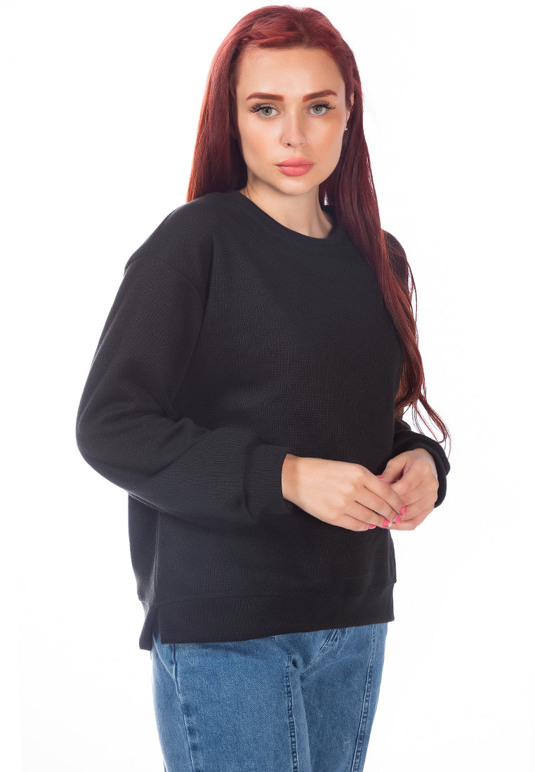 A cozy knitted long sleeve pullover sweatshirt with a crew neckline, ribbed hem, and side slits, made from soft cotton fabric.