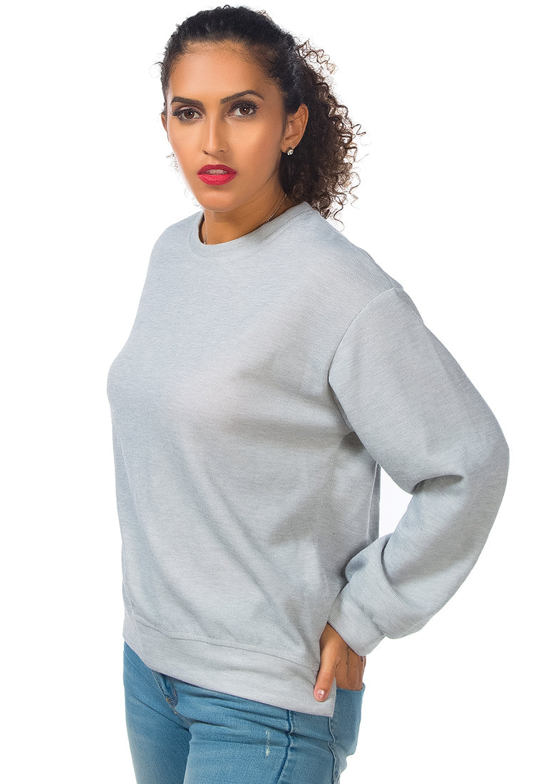 A cozy knitted long sleeve pullover sweatshirt with a crew neckline, ribbed hem, and side slits, made from soft cotton fabric.