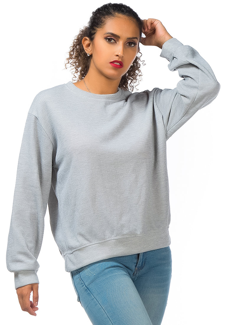 A cozy knitted long sleeve pullover sweatshirt with a crew neckline, ribbed hem, and side slits, made from soft cotton fabric.