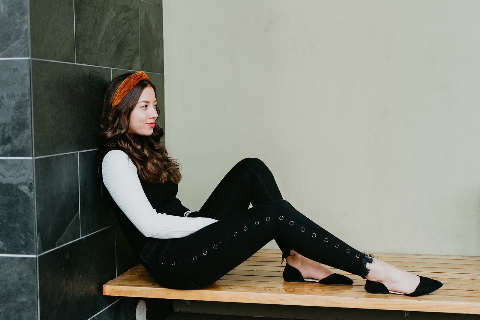 Woman sitting on bench, relaxed.