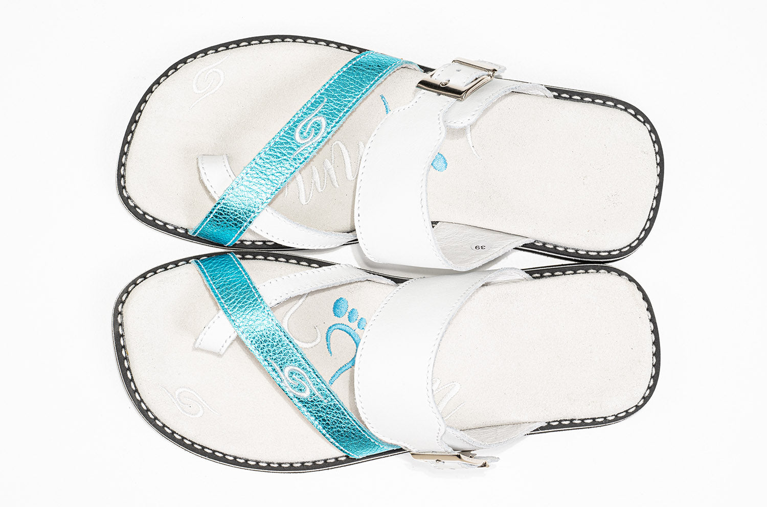 White sandals with blue straps.