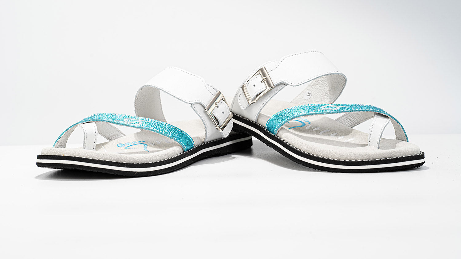 White sandals with turquoise straps.