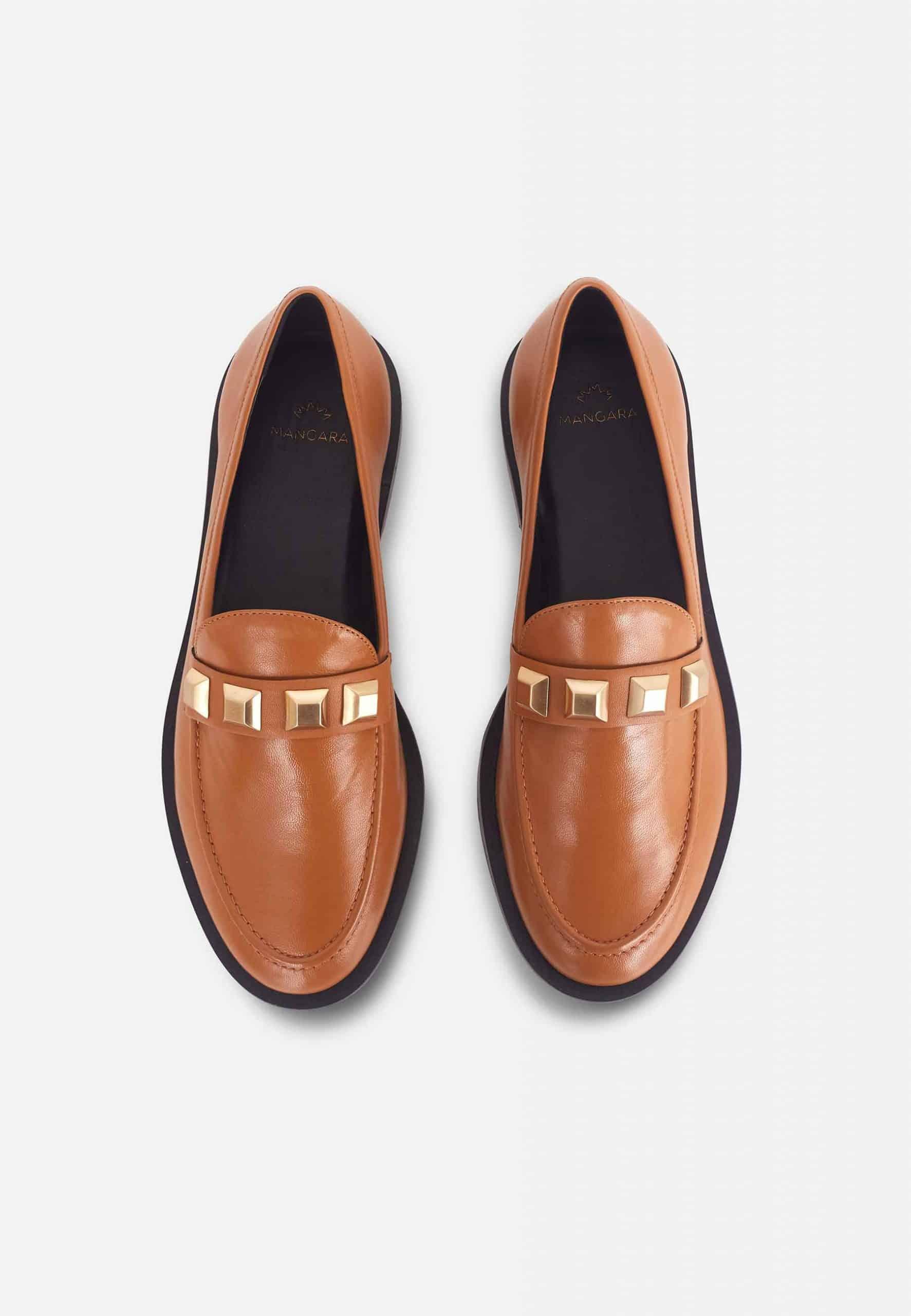 A pair of Mangará Women's Loafers Caete Leather showcasing premium goat leather, round toe design, and stylish metal studs.