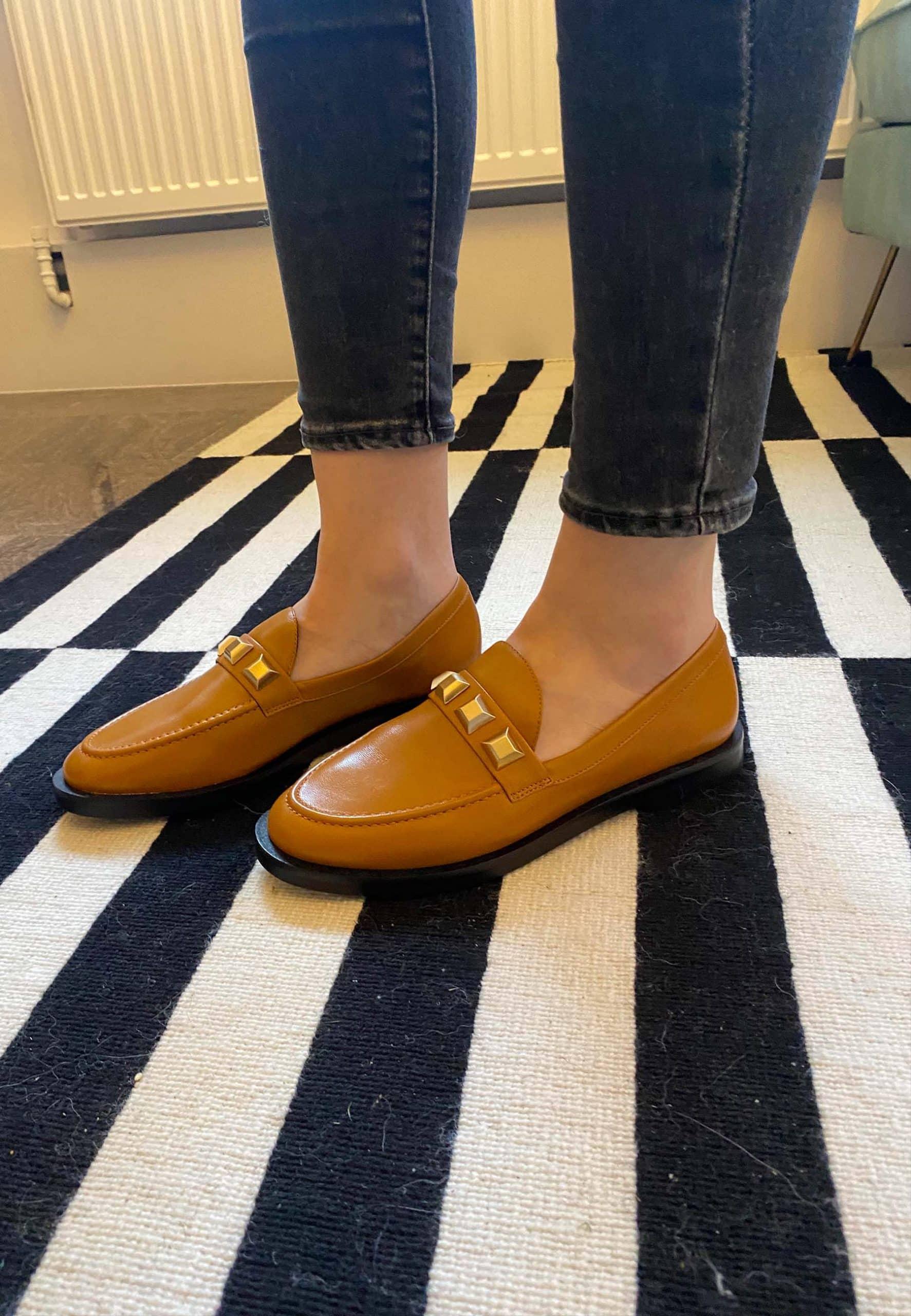 A pair of Mangará Women's Loafers Caete Leather showcasing premium goat leather, round toe design, and stylish metal studs.