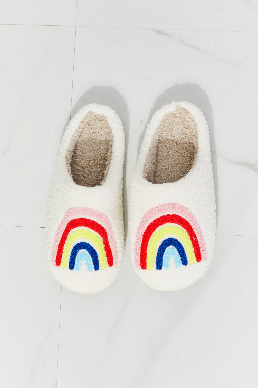 MMShoes Rainbow Plush Slipper featuring a colorful rainbow graphic design with soft faux fur material and a durable rubber sole.