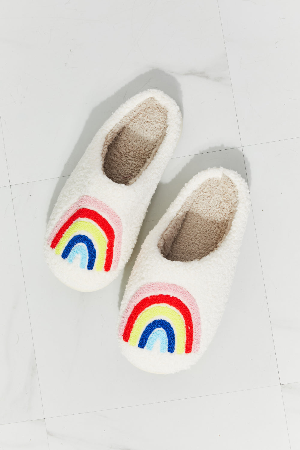 MMShoes Rainbow Plush Slipper featuring a colorful rainbow graphic design with soft faux fur material and a durable rubber sole.