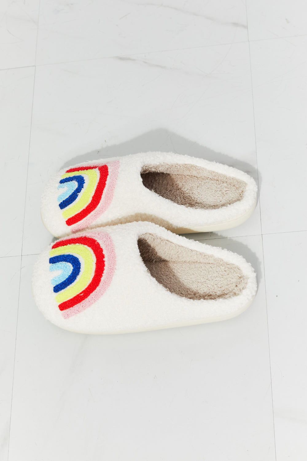 MMShoes Rainbow Plush Slipper featuring a colorful rainbow graphic design with soft faux fur material and a durable rubber sole.