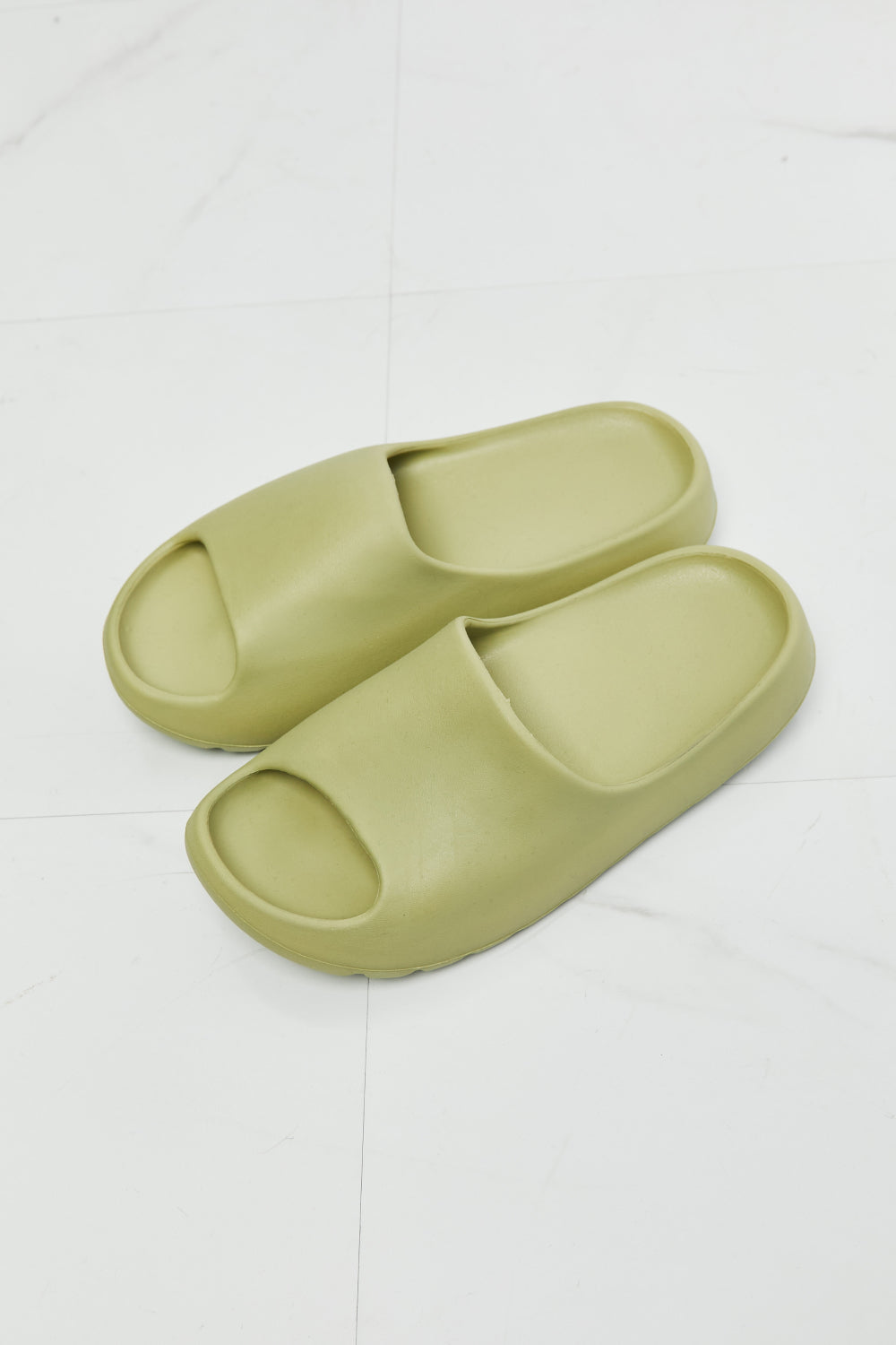 NOOK JOI In My Comfort Zone Slides in vibrant green color with a durable rubber sole, showcasing an open toe design for casual wear.