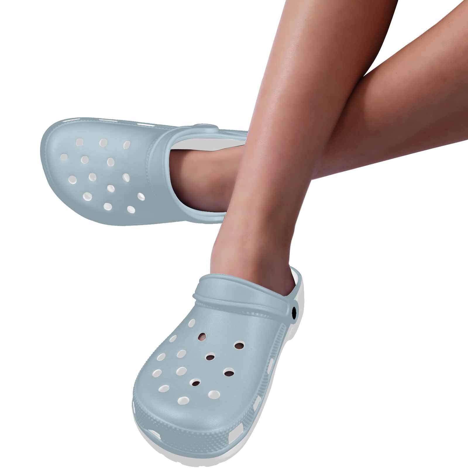 Pastel blue adult clogs made from lightweight EVA material, featuring ventilation ports and pivoting heel straps for a secure fit.