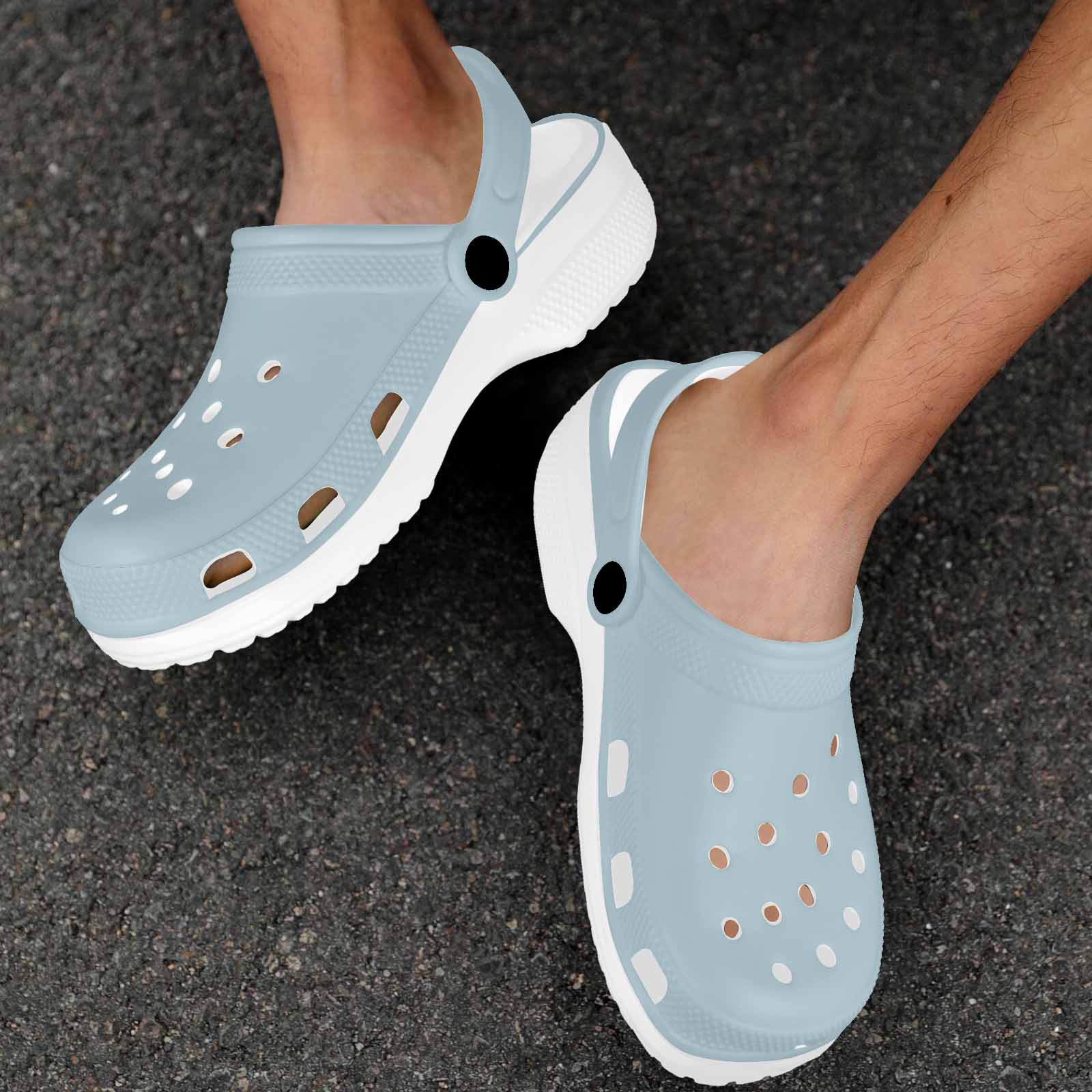 Pastel blue adult clogs made from lightweight EVA material, featuring ventilation ports and pivoting heel straps for a secure fit.