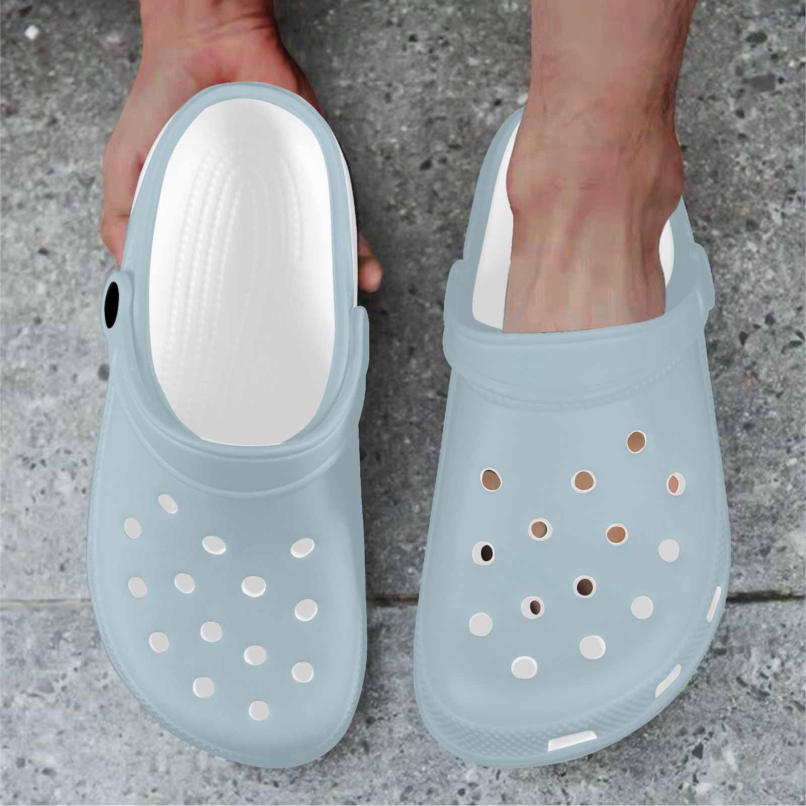 Pastel blue adult clogs made from lightweight EVA material, featuring ventilation ports and pivoting heel straps for a secure fit.