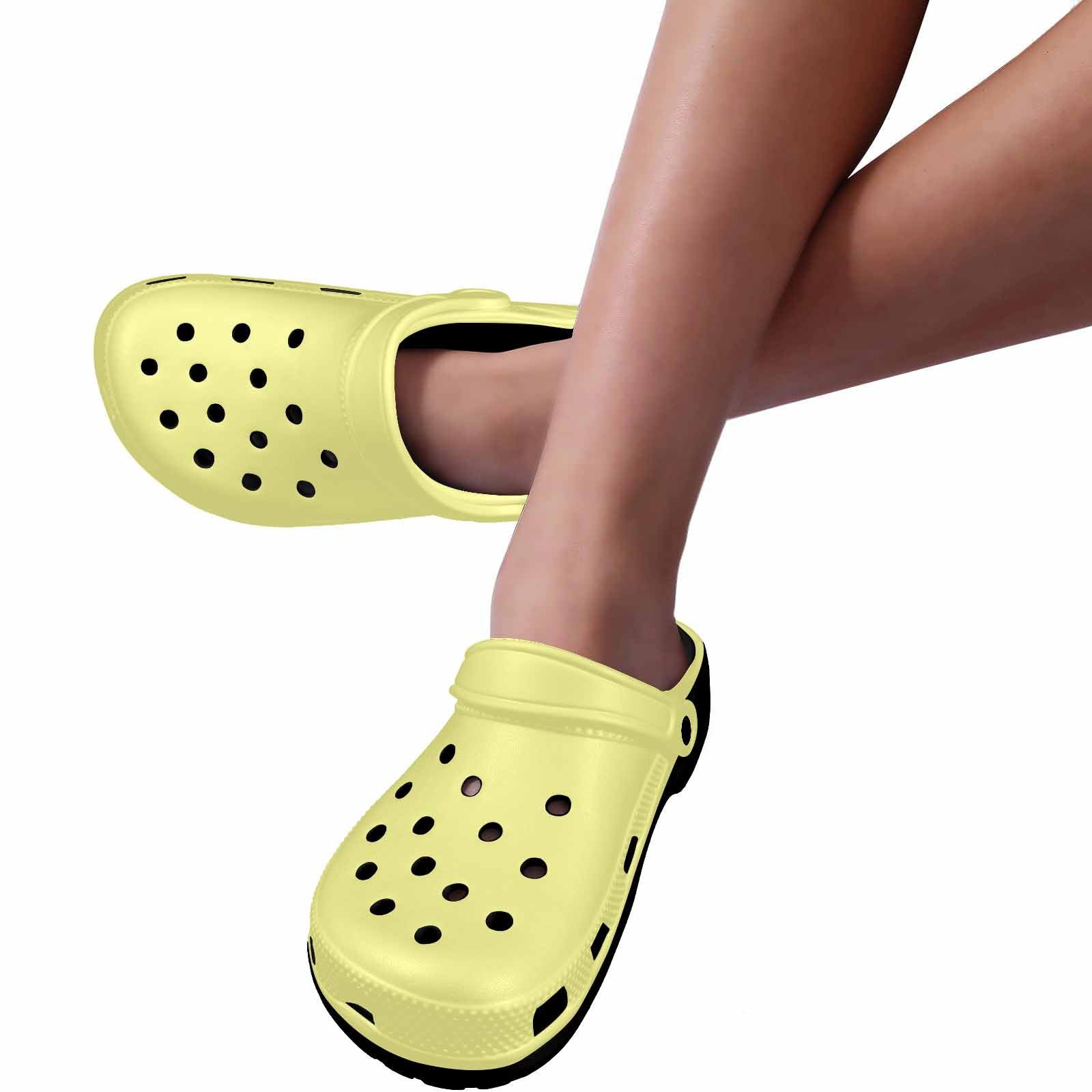 Pastel yellow adult clogs made from lightweight EVA material with ventilation ports and pivoting heel straps.