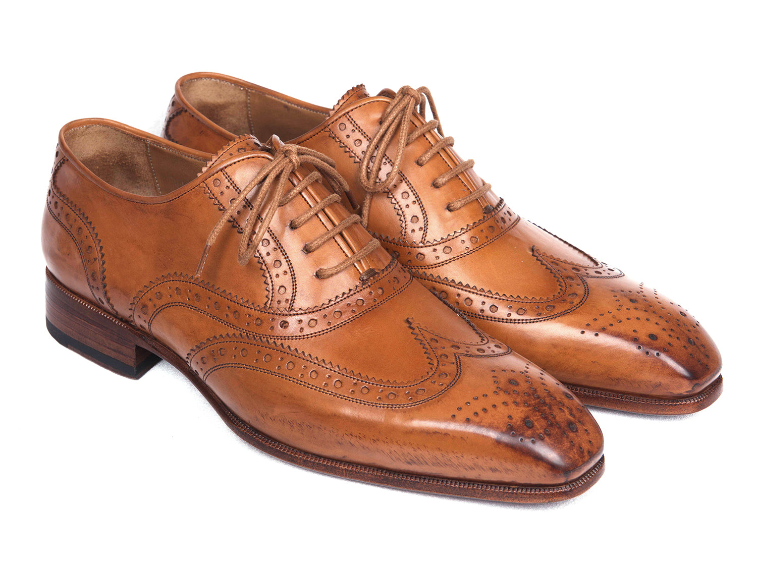 Paul Parkman Wingtip Oxfords in Cognac, featuring hand-burnished leather upper and antiqued leather sole, showcasing elegant brogue detailing.