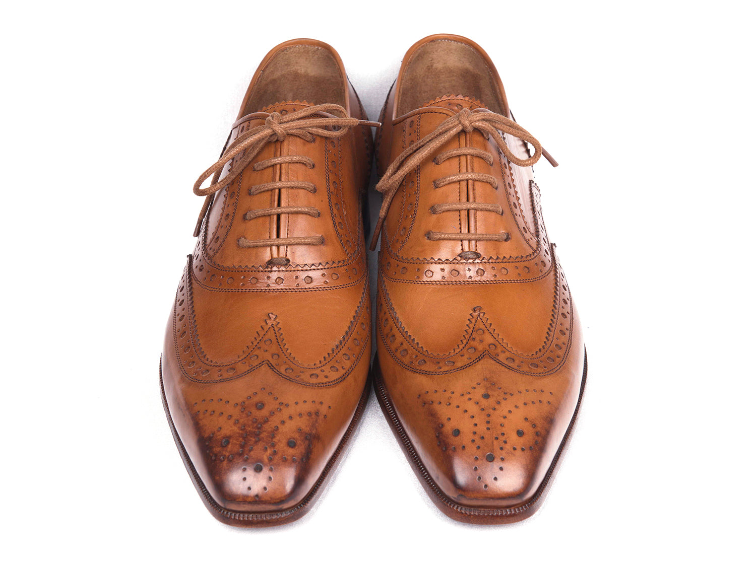 Paul Parkman Wingtip Oxfords in Cognac, featuring hand-burnished leather upper and antiqued leather sole, showcasing elegant brogue detailing.