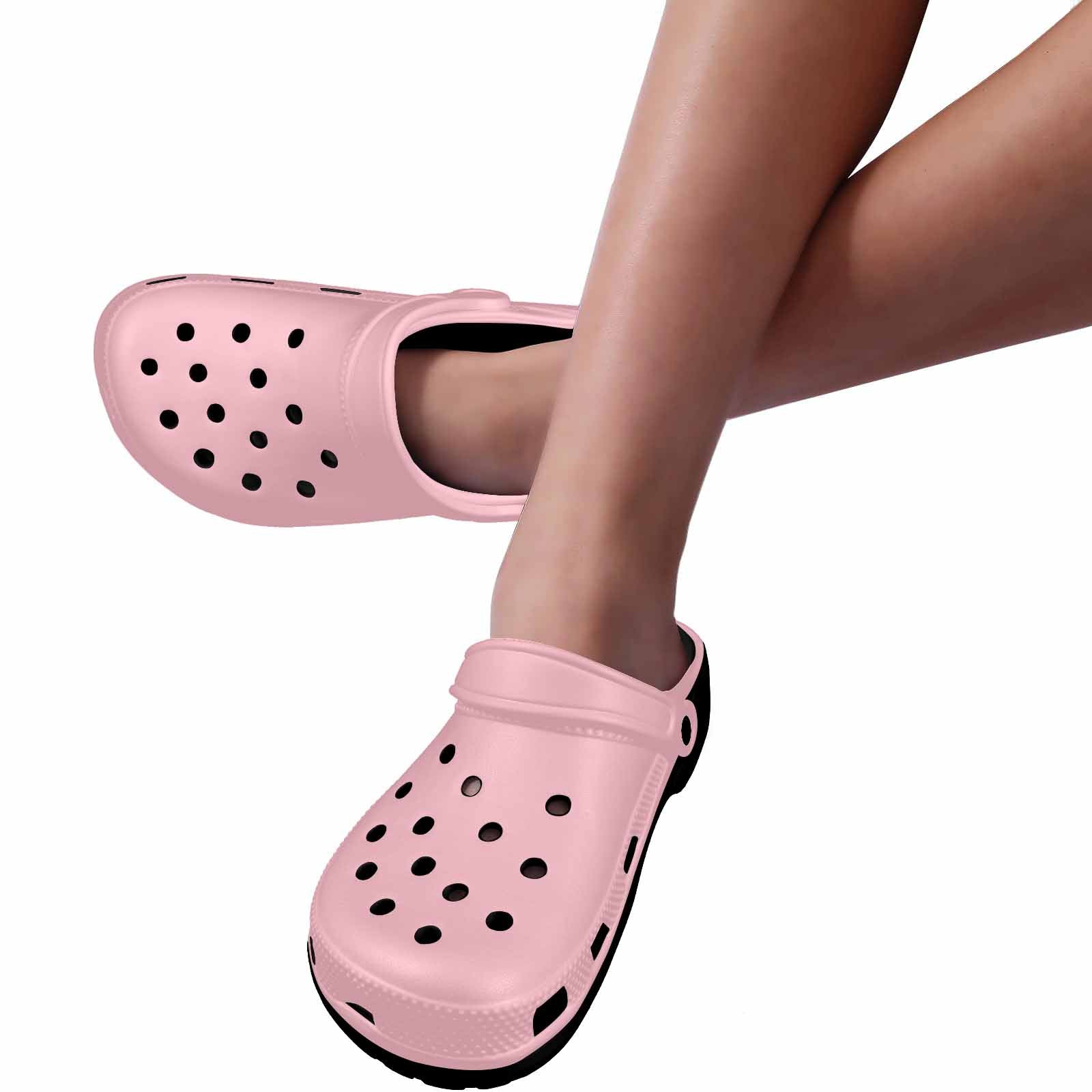 A pair of pink adult clogs made from lightweight EVA material, featuring ventilation ports and pivoting heel straps for a secure fit.