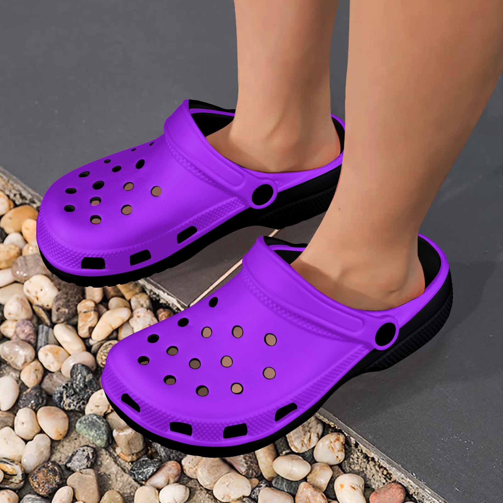 Purple adult clogs made from lightweight EVA material with ventilation ports and pivoting heel straps.