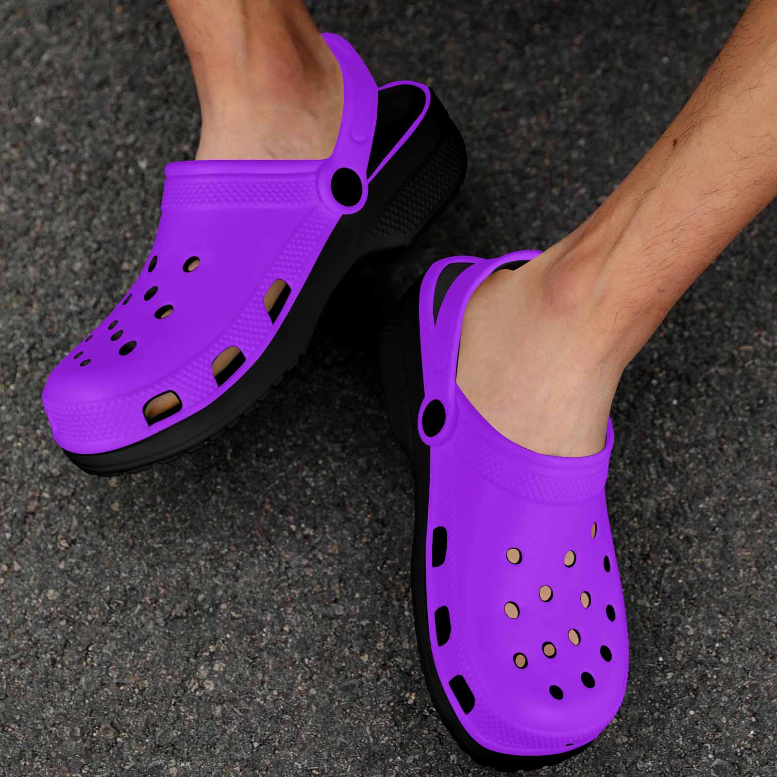 Purple adult clogs made from lightweight EVA material with ventilation ports and pivoting heel straps.