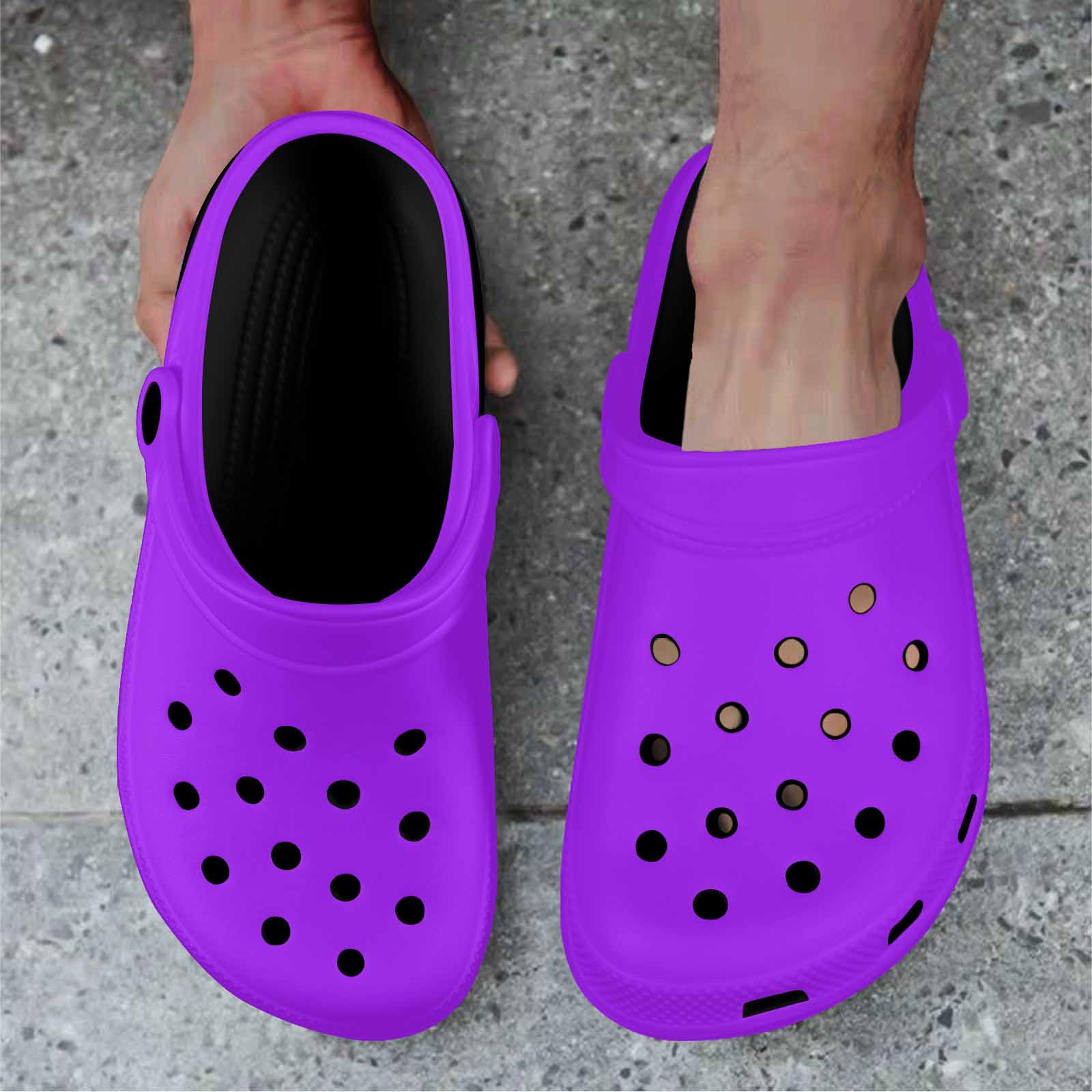 Purple adult clogs made from lightweight EVA material with ventilation ports and pivoting heel straps.