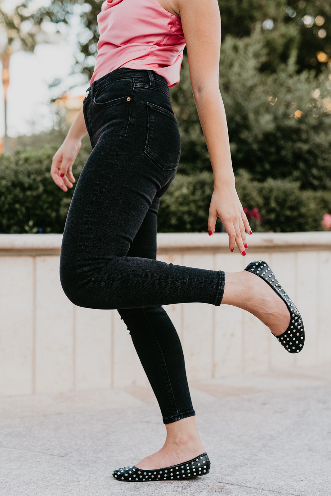 A pair of stylish black studded deluxe Rollasoles in a high heel carry bag, showcasing their chic design and practicality.