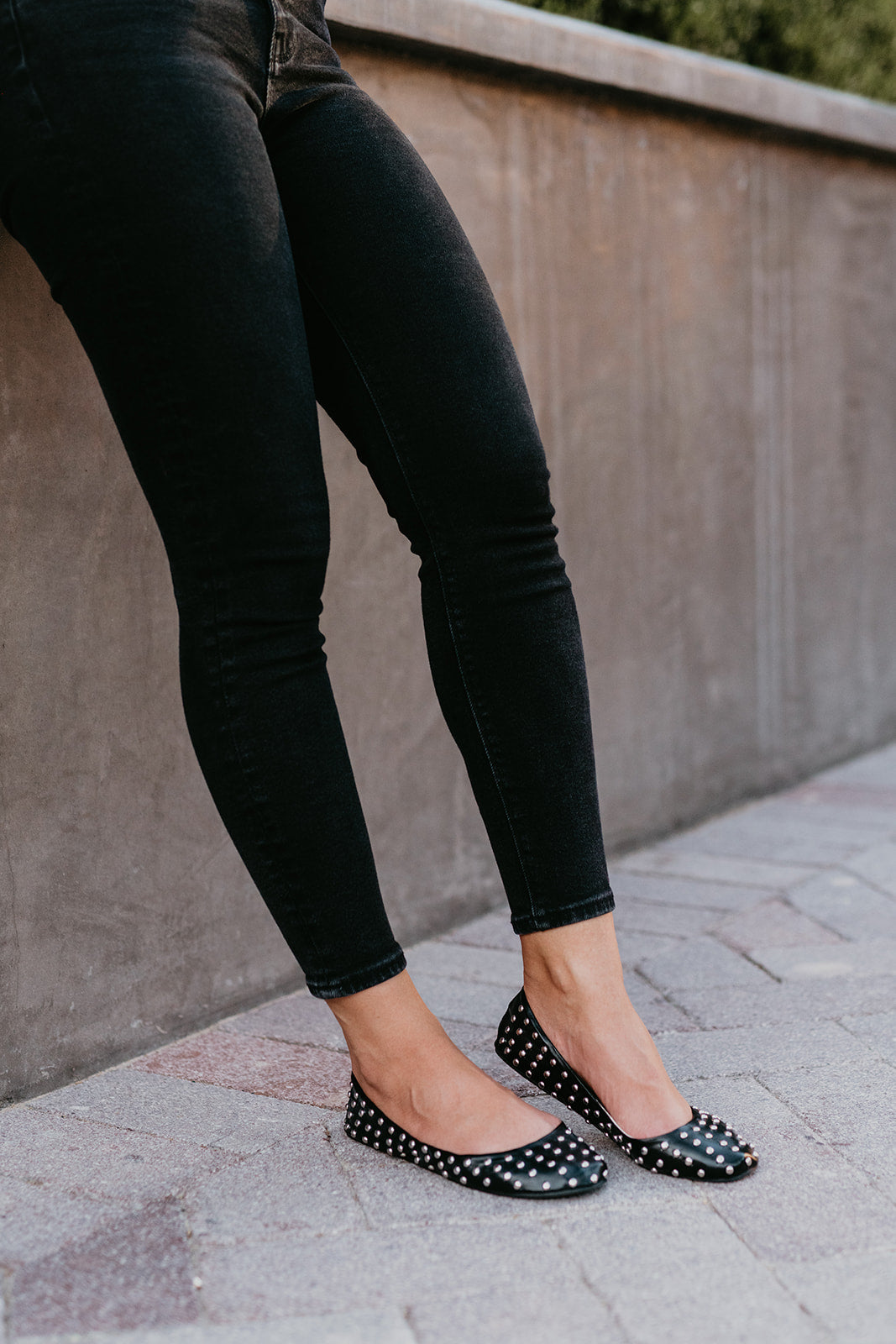 A pair of stylish black studded deluxe Rollasoles in a high heel carry bag, showcasing their chic design and practicality.