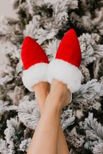 Cozy Santa Baby festive slippers with a fun design, perfect for Christmas celebrations and lounging at home.