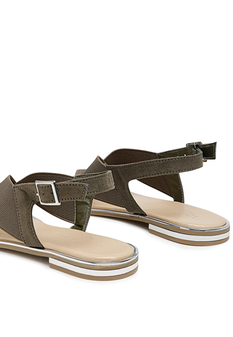 Snuggle Slingback Flat Sandals featuring a stylish cross strap design and a sleek base with silver lining.