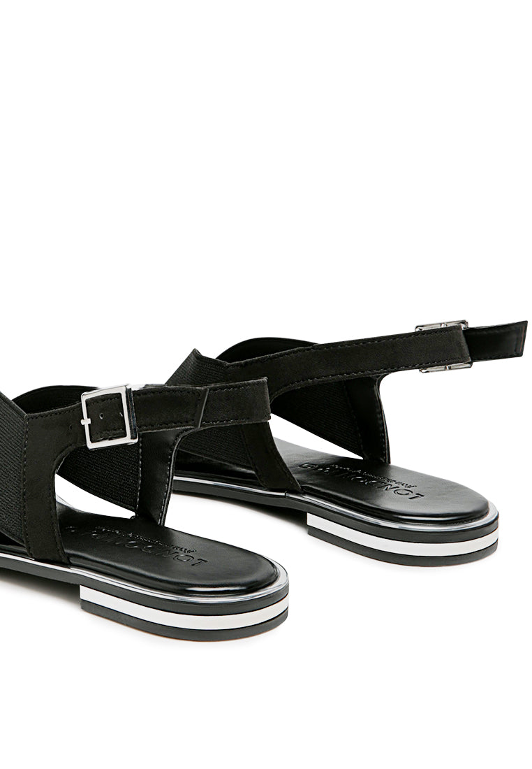 Snuggle Slingback Flat Sandals featuring a stylish cross strap design and a sleek base with silver lining.