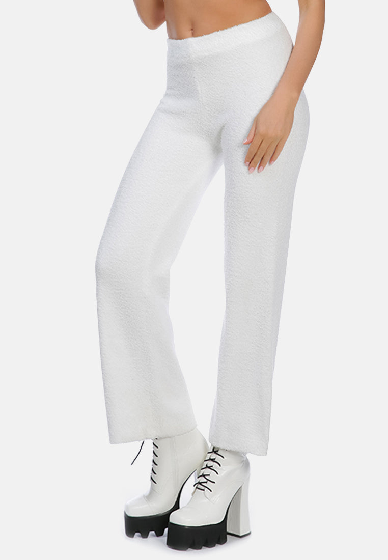 A pair of solid high waist wide leg trousers made from breathable cotton, featuring an elasticated waistband and ankle-length cut.