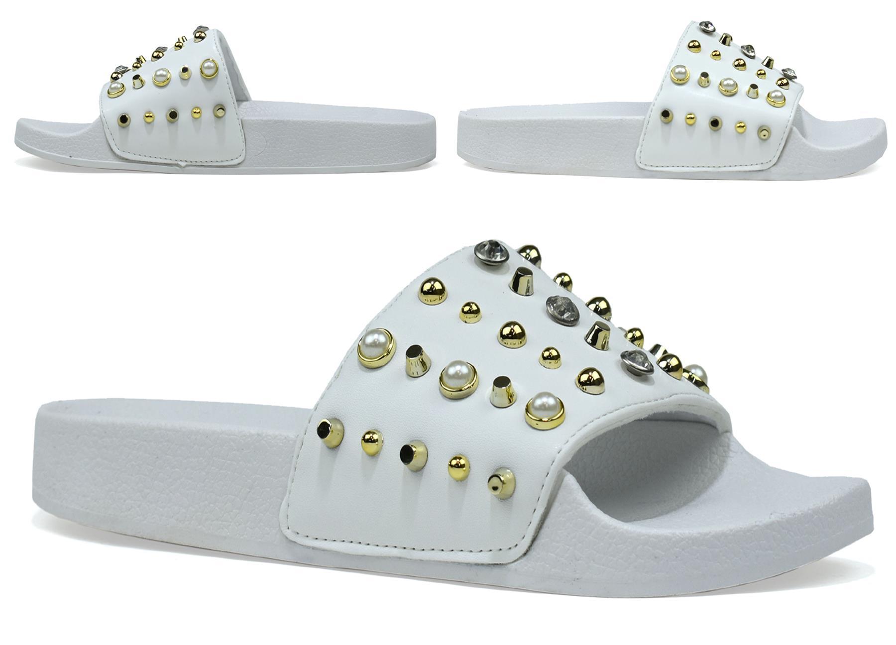 Stylish black and white studded sliders with gold accents, perfect for casual wear.