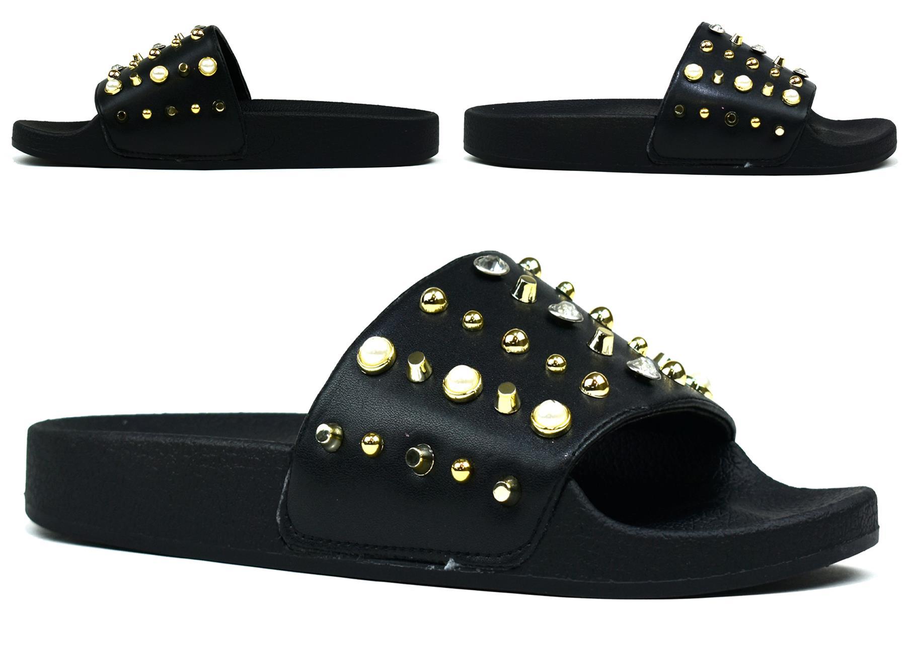 Stylish black and white studded sliders with gold accents, perfect for casual wear.